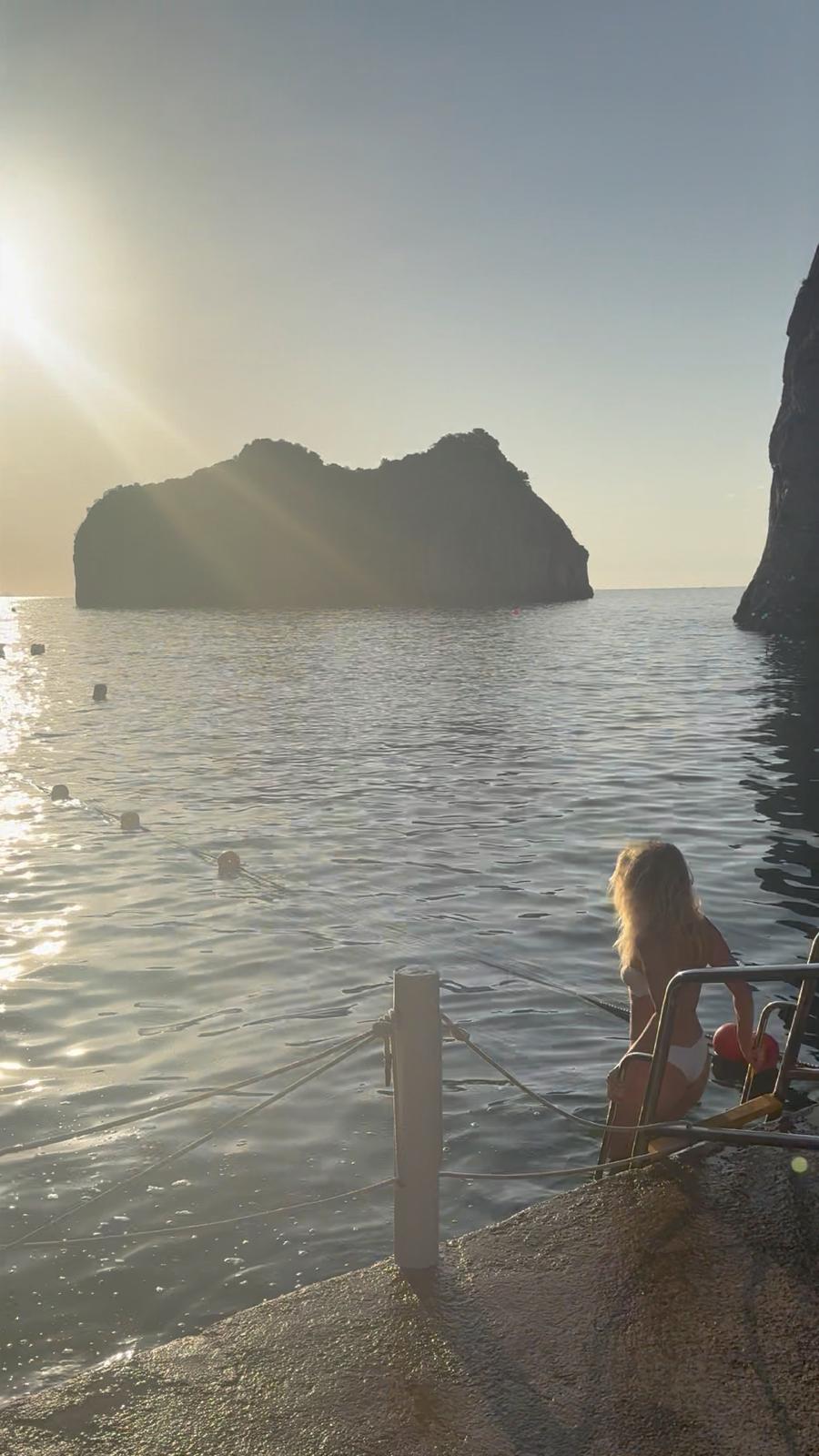 A morning swim by the Faraglioni